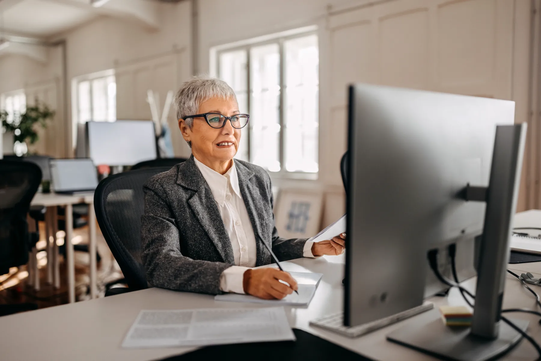Senior well dressed businesswoman working from the modern office