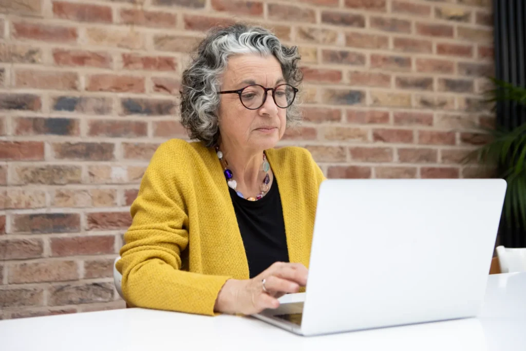 Mature woman using a laptop computer at home